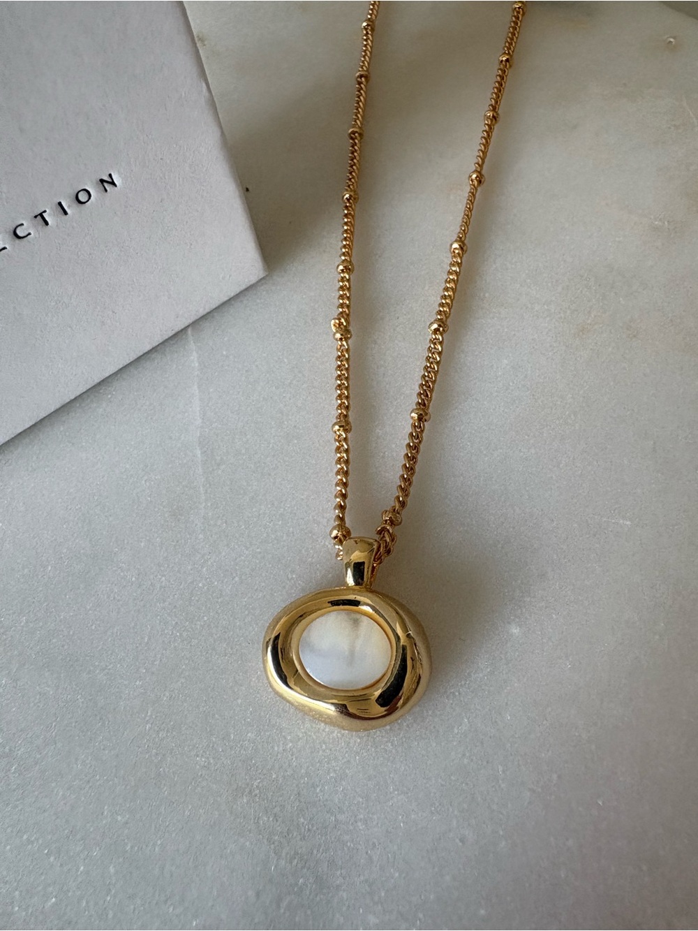 Elle Gold-Tone Pendant Necklace with White Center